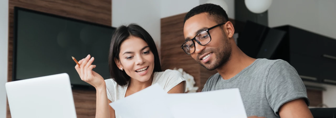 happy couple reviewing savings for emergency fund
